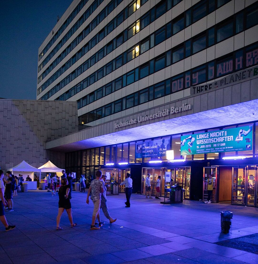 Vorplatz des TU-Hauptgebäudes bei Nacht mit bläulicher Illumination