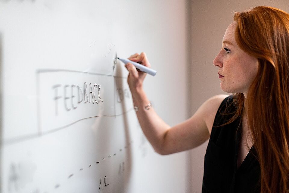 Woman writing on an whiteboard