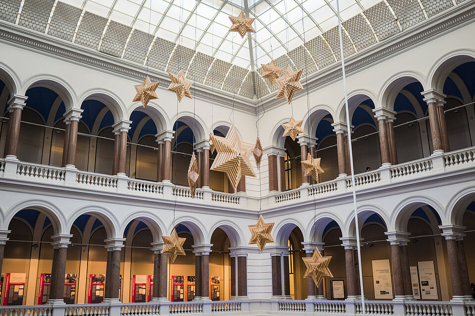 View of the atrium with handcrafted wooden stars hanging from the ceiling as Christmas decorations